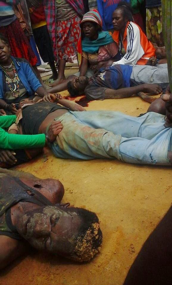 Family members grieve over the bodies of West Papuans massacred by the Indonesian soldiers in Paniai, West Papua yesterday