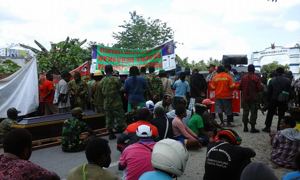 Indonesian police blocking the funeral procession of Kaleb Bagau